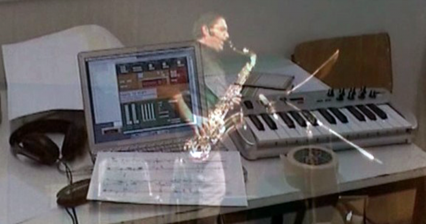 Andreas playing saxophone, overlaid on his laptop and keyboard rig
